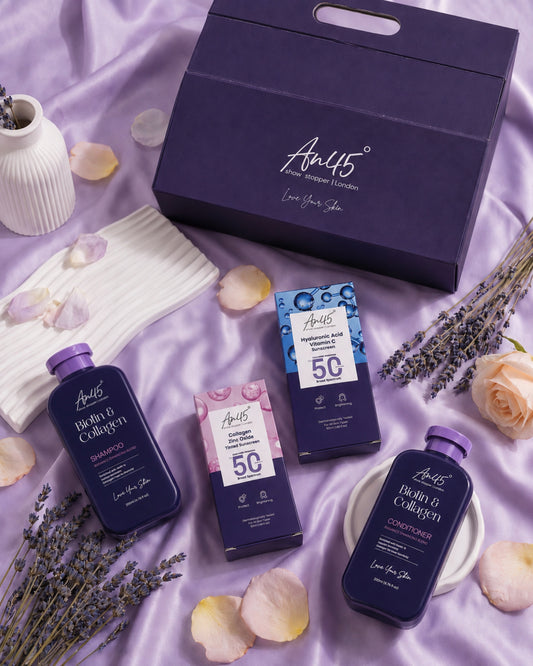 The four AN45° products from the Rakhi hamper laid out on lavender satin with lavender sprigs and rose petals, the purple gift box behind