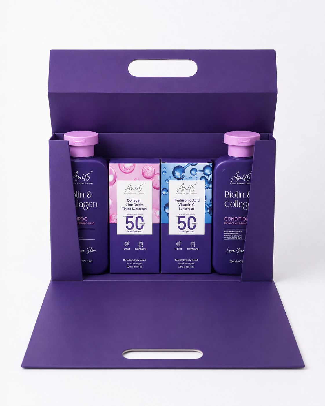 AN45° Rakhi Gift Hamper — the purple keepsake box opened, with the Biotin & Collagen Shampoo, SPF 50 Tinted Sunscreen, SPF 50 Sunscreen Fluid and Biotin & Collagen Conditioner inside