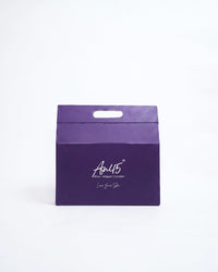 The AN45° purple keepsake gift box, closed, with its carry handle